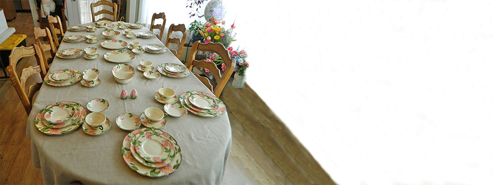 Picture of a large dinner table setting.